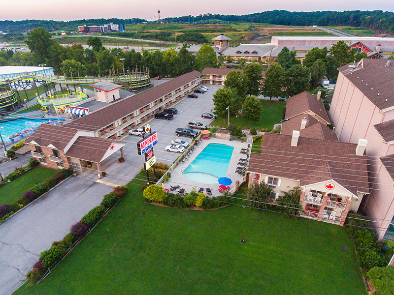 Aerial view of the hotel exterior with pool and parking lot.
